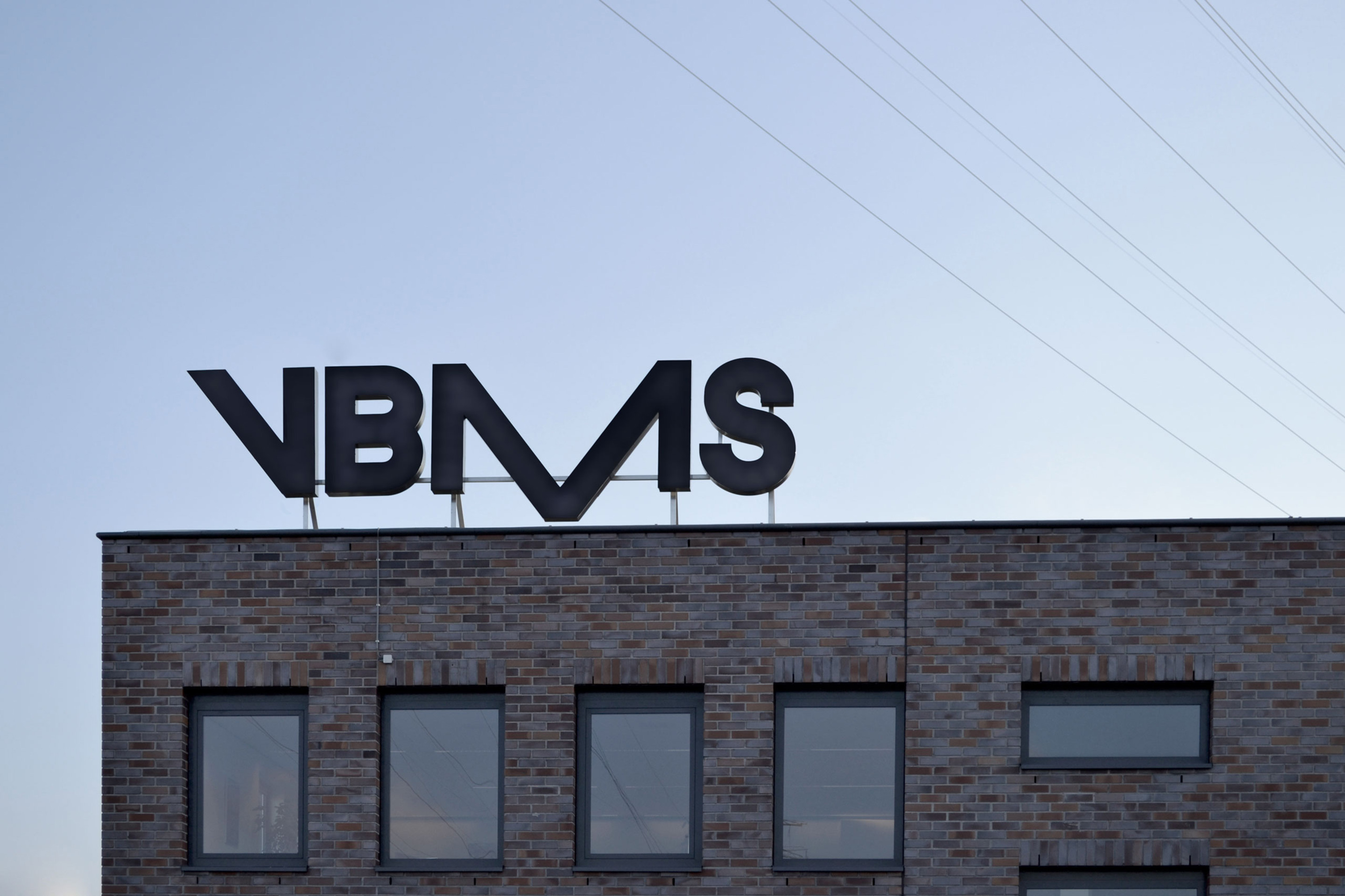 studio dumbar design visual brand identity for VBMS expert in offshore installations logo building hoarding design